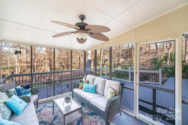 unfurnished sunroom with ceiling fan and vaulted ceiling