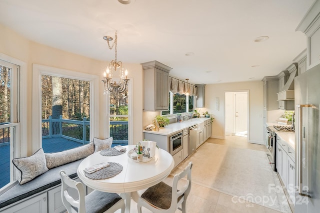 interior space featuring a chandelier, light tile patterned floors, and a wealth of natural light