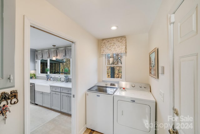 washroom featuring separate washer and dryer and sink