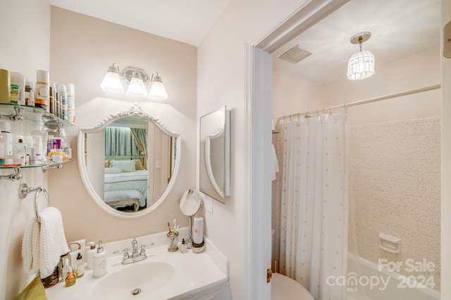 bathroom with shower / bath combo with shower curtain and sink