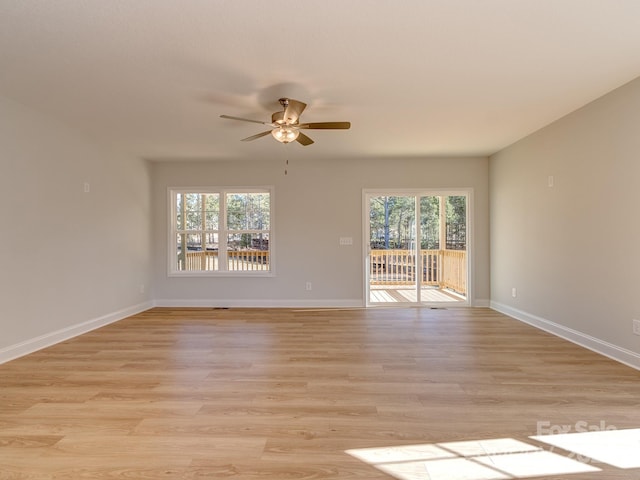 spare room with light wood-type flooring and ceiling fan