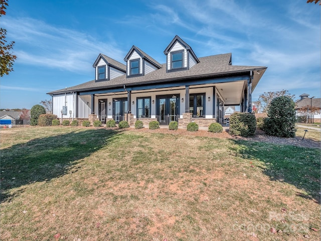 cape cod-style house featuring a porch and a front lawn