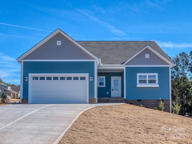 view of front of property with crawl space, concrete driveway, a garage, and roof with shingles