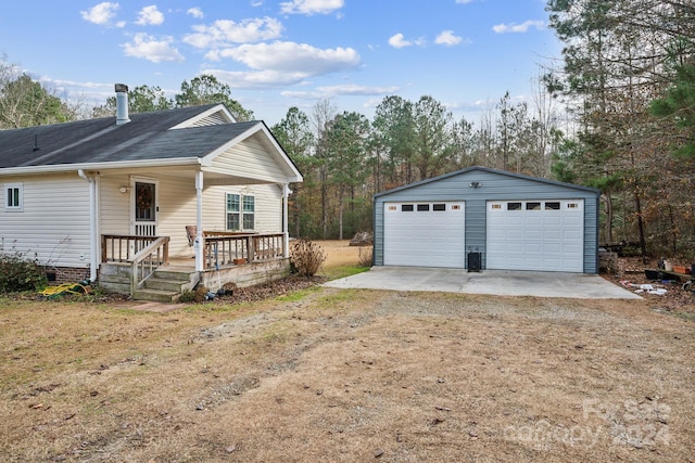 view of front of home with covered porch, a garage, and an outdoor structure