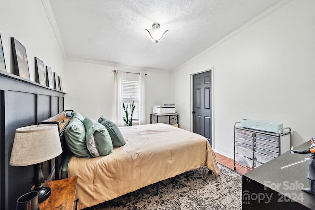 bedroom with vaulted ceiling, wood-type flooring, a textured ceiling, and ornamental molding