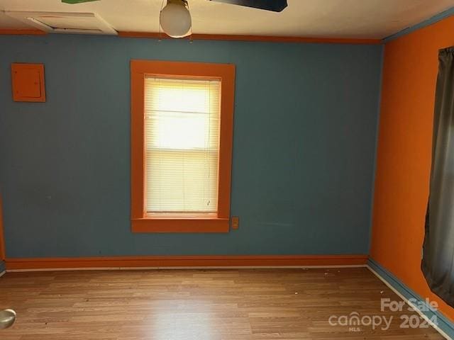 spare room featuring crown molding, ceiling fan, and light hardwood / wood-style floors