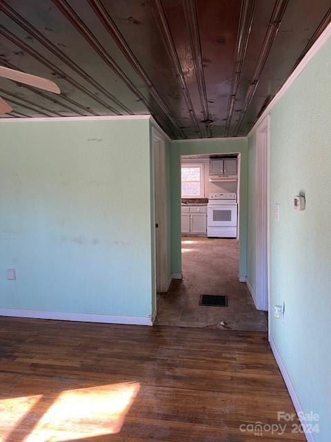 corridor with hardwood / wood-style floors