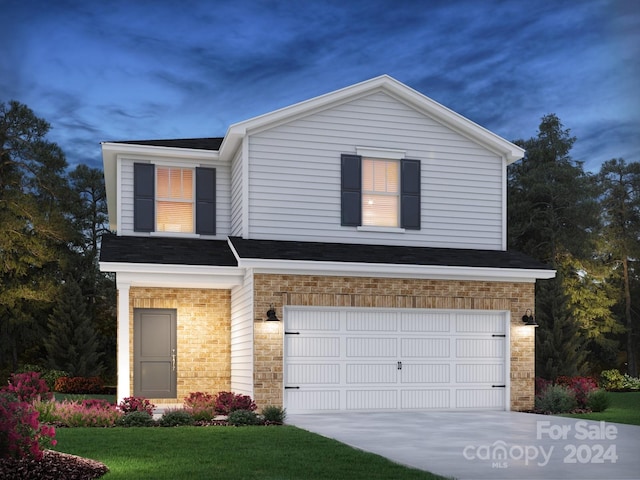 view of front of property with a front yard and a garage