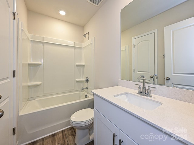 full bathroom featuring shower / washtub combination, vanity, wood-type flooring, and toilet