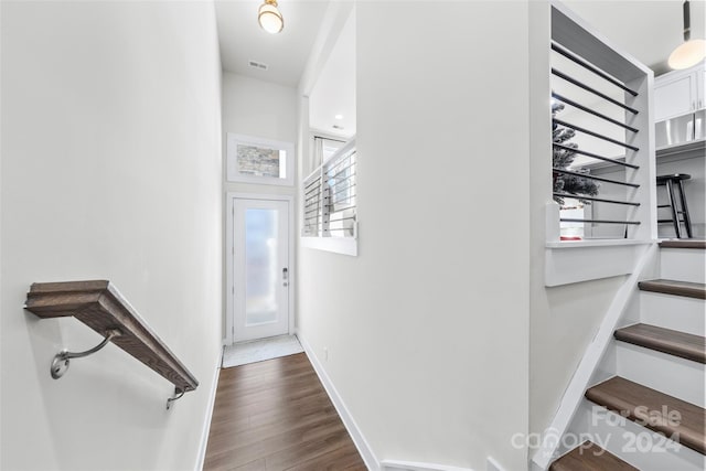 stairs with hardwood / wood-style floors