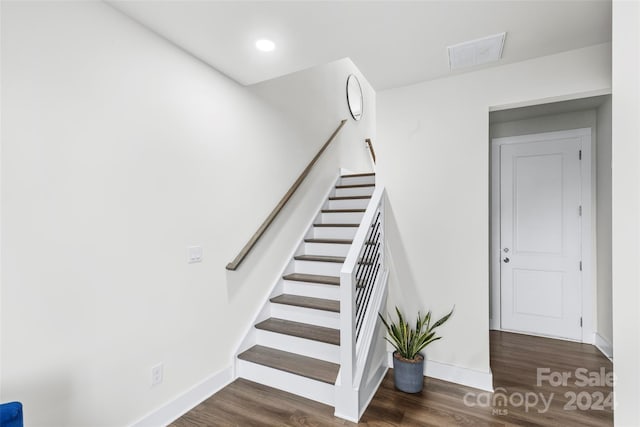 staircase featuring hardwood / wood-style floors