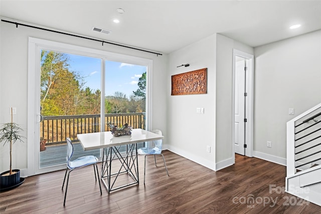 dining room featuring dark wood-type flooring and a wealth of natural light