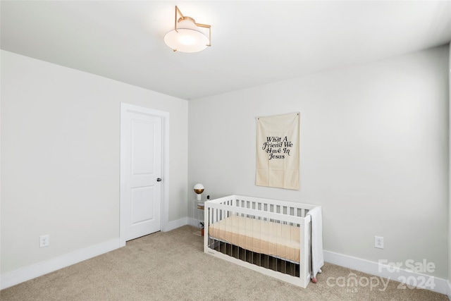 carpeted bedroom with a crib