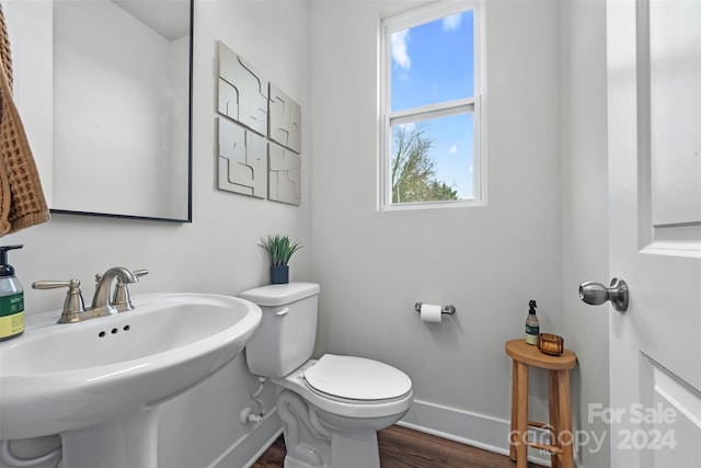 bathroom featuring hardwood / wood-style flooring, toilet, and sink