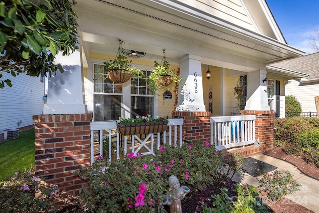 exterior space with a porch and cooling unit