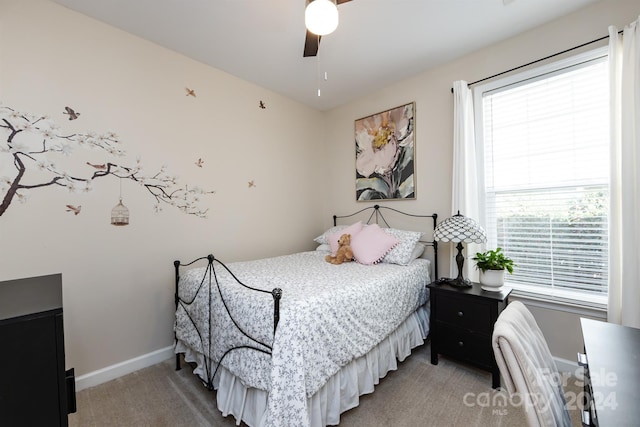 carpeted bedroom with multiple windows and ceiling fan