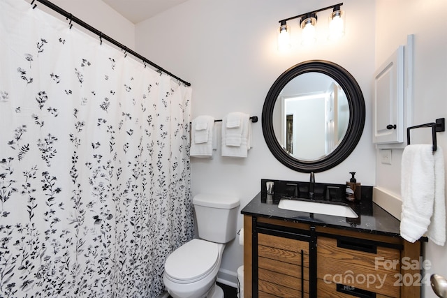 bathroom with a shower with curtain, vanity, and toilet