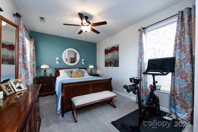 carpeted bedroom with ceiling fan and multiple windows