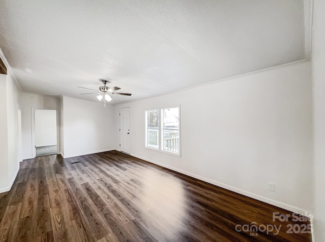 spare room with a textured ceiling, dark hardwood / wood-style flooring, ceiling fan, and crown molding