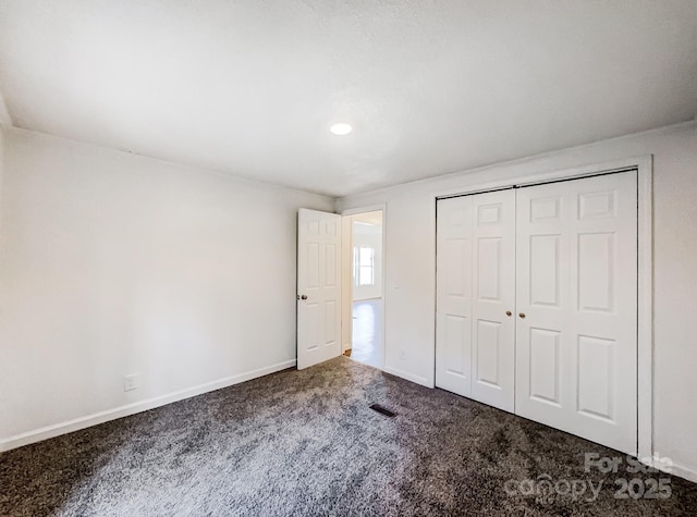 unfurnished bedroom featuring a closet and carpet floors