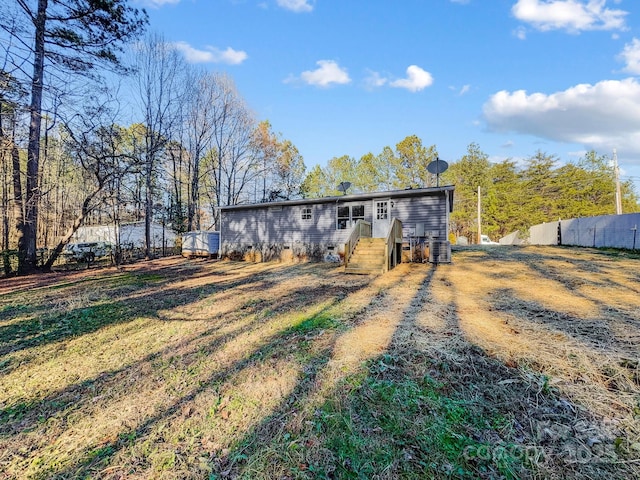 rear view of house with a yard