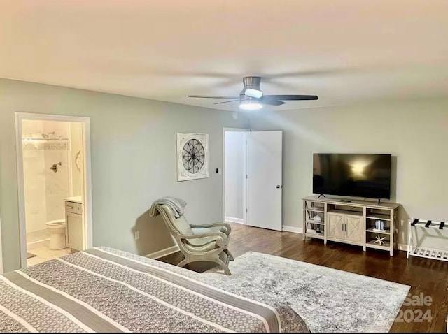 bedroom with ceiling fan, ensuite bathroom, and dark wood-type flooring