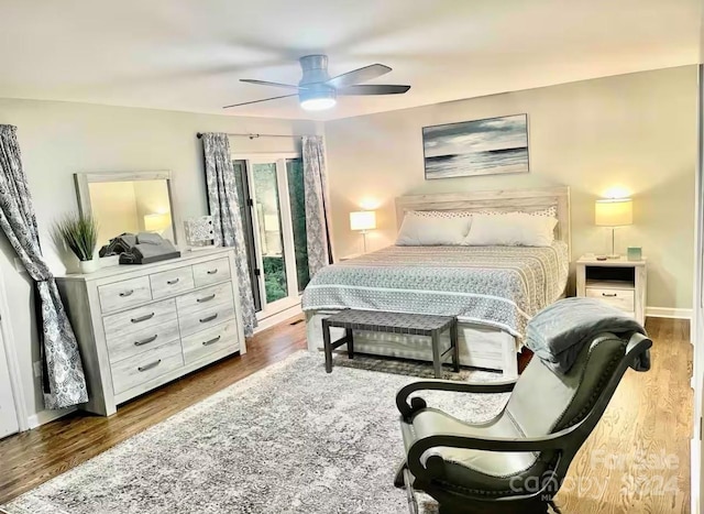 bedroom with dark hardwood / wood-style flooring and ceiling fan