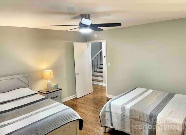 bedroom with hardwood / wood-style floors and ceiling fan