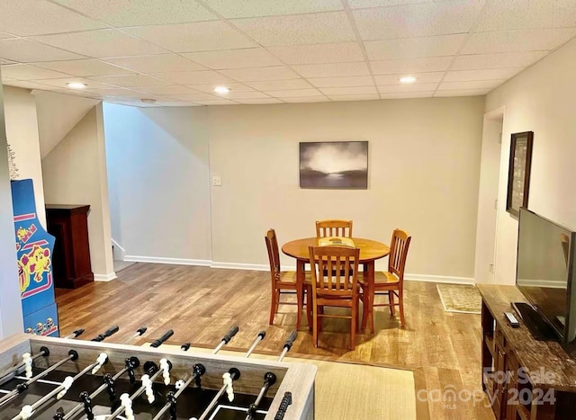 dining room featuring a paneled ceiling and light hardwood / wood-style floors