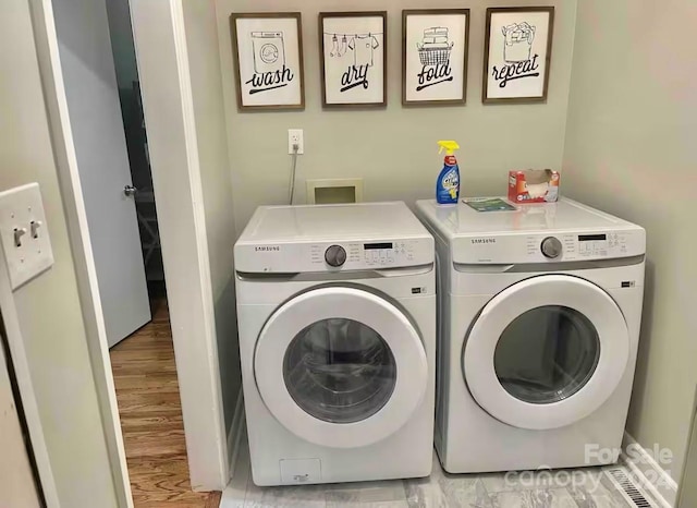 washroom featuring light hardwood / wood-style flooring and washer and dryer