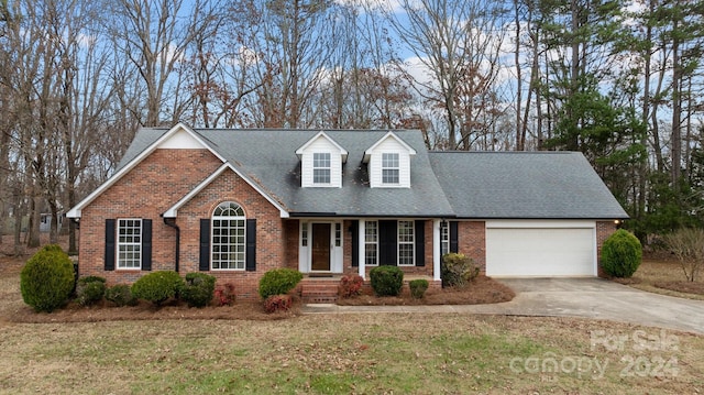 view of front of property featuring a front yard and a garage