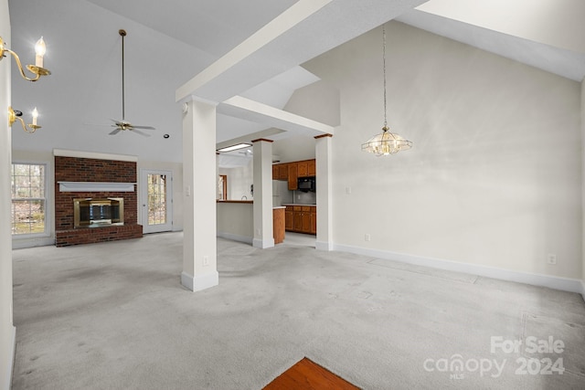 unfurnished living room featuring a fireplace, light colored carpet, high vaulted ceiling, and ceiling fan