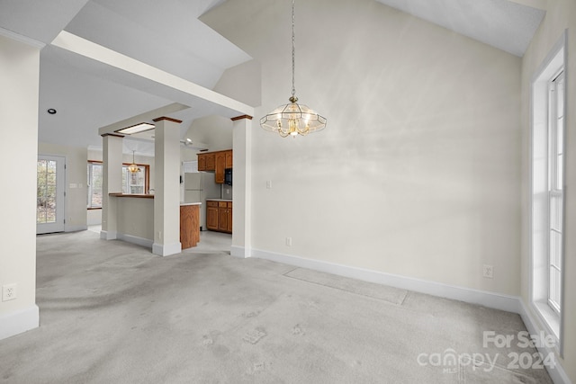 interior space featuring high vaulted ceiling, light colored carpet, and a notable chandelier