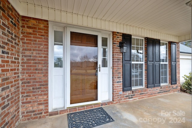 doorway to property with a porch