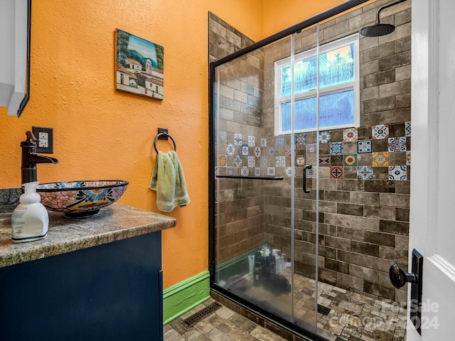 bathroom with an enclosed shower and sink