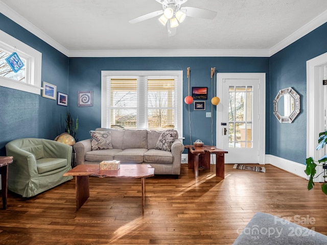 living room with dark hardwood / wood-style floors, ceiling fan, and crown molding