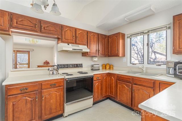 kitchen featuring sink, vaulted ceiling, and electric stove