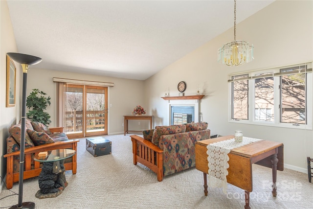 living room with light colored carpet, lofted ceiling, and an inviting chandelier