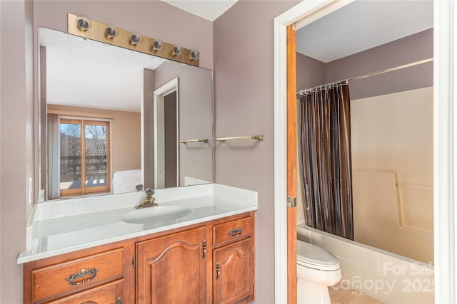 full bathroom with a textured ceiling, shower / bath combo, toilet, and vanity