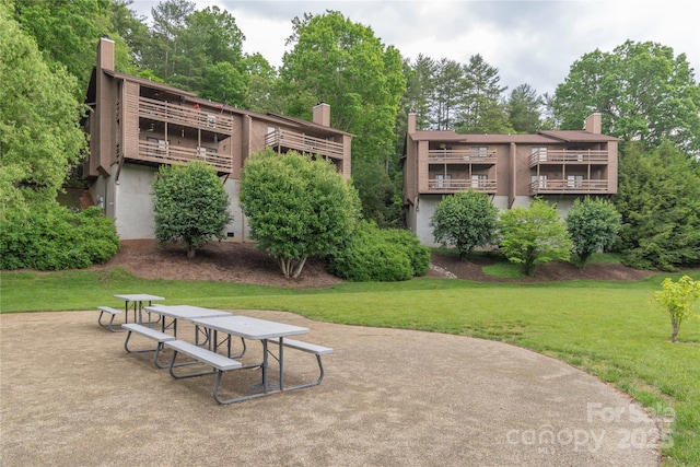 back of property featuring a patio and a yard