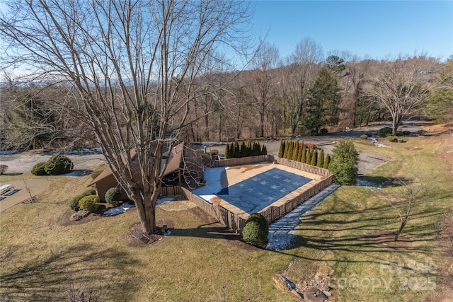 view of pool with a lawn