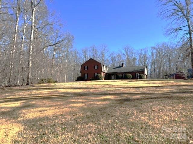 view of side of home with a yard