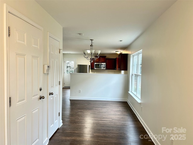 interior space with dark hardwood / wood-style floors and a chandelier