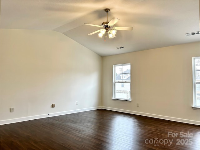 empty room featuring lofted ceiling, ceiling fan, and dark hardwood / wood-style floors