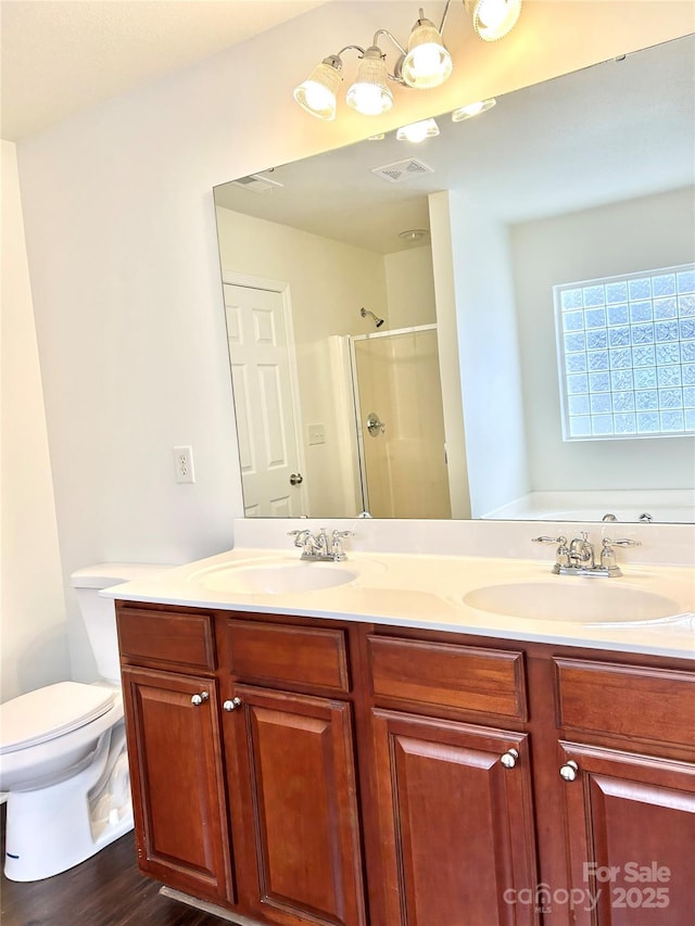 bathroom with hardwood / wood-style flooring, an enclosed shower, vanity, and toilet