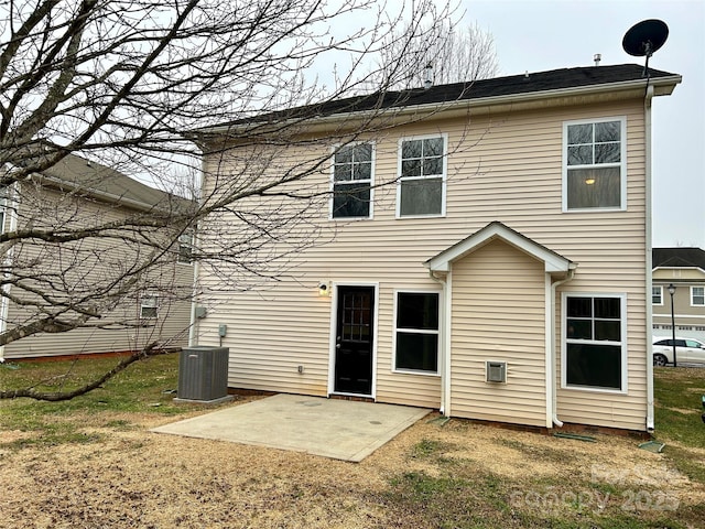 rear view of house with a lawn, central air condition unit, and a patio area