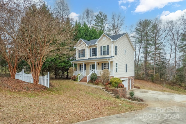 view of front property with covered porch and a garage