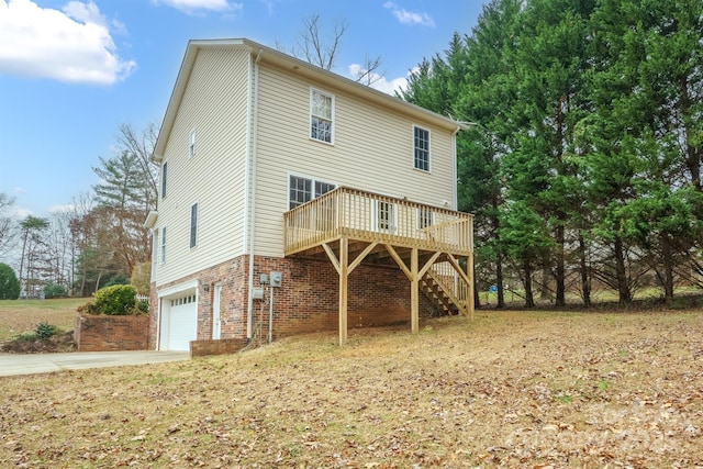 rear view of house with a garage and a deck