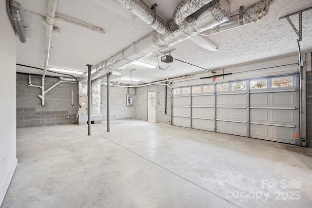 garage featuring a garage door opener and electric panel