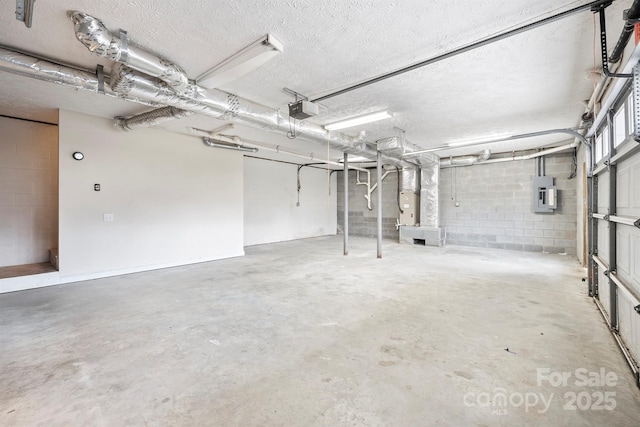 garage with a garage door opener and electric panel